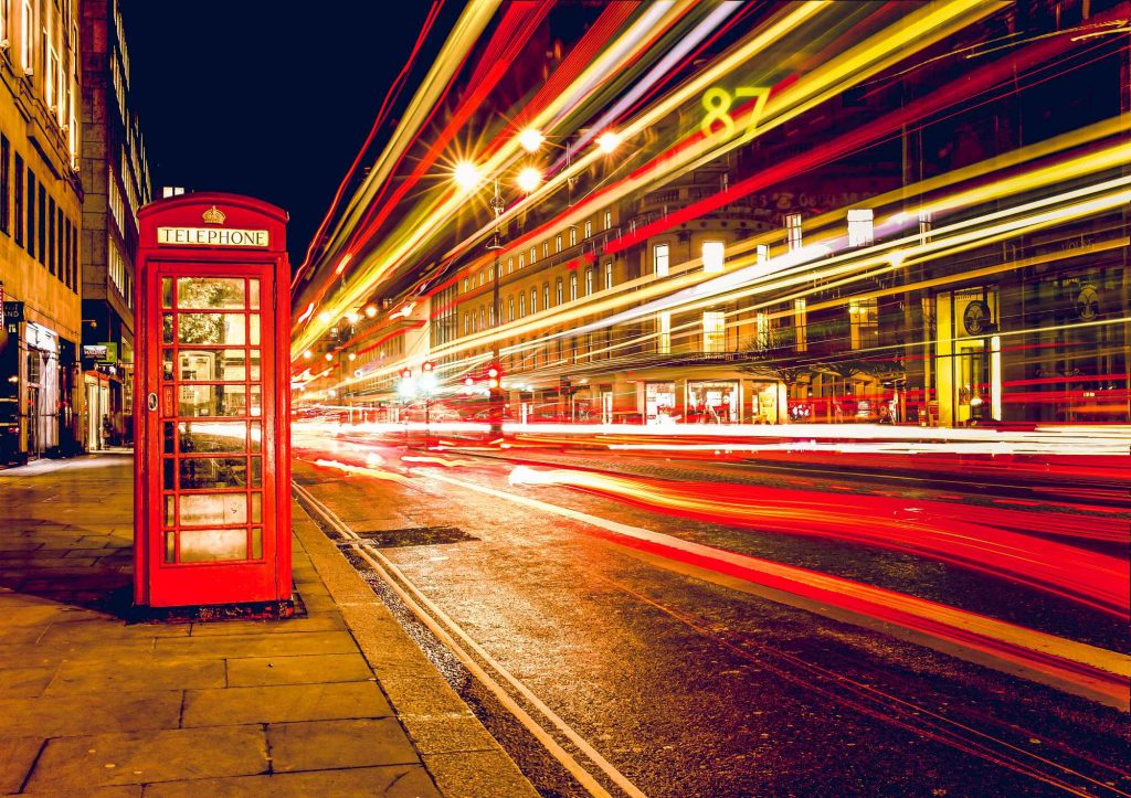 A photograph with a red phone box and light trails